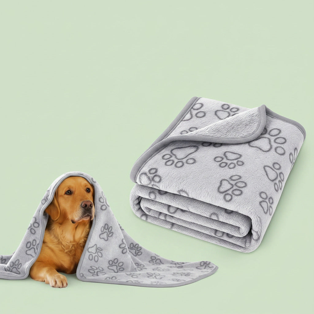 Gray pet blanket with paw prints and a dog peeking out from under it on a white background