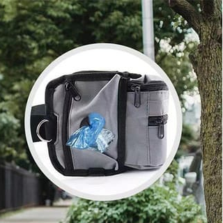 Gray bag with a blue plastic bag inside, outdoors.