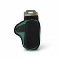 Pet grooming brush with green handle and black bristles on a white background