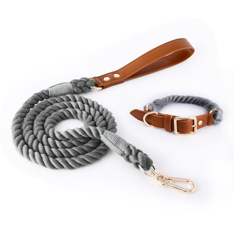 Gray rope dog leash with brown leather handle and matching collar on a white background