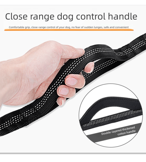 Close-range dog control handle with a hand holding it, emphasizing comfort and safety.