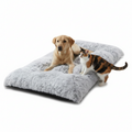 Dog and cat on a fluffy gray pet bed against a white background