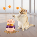 Cat playing with a colorful cat toy on a white background
